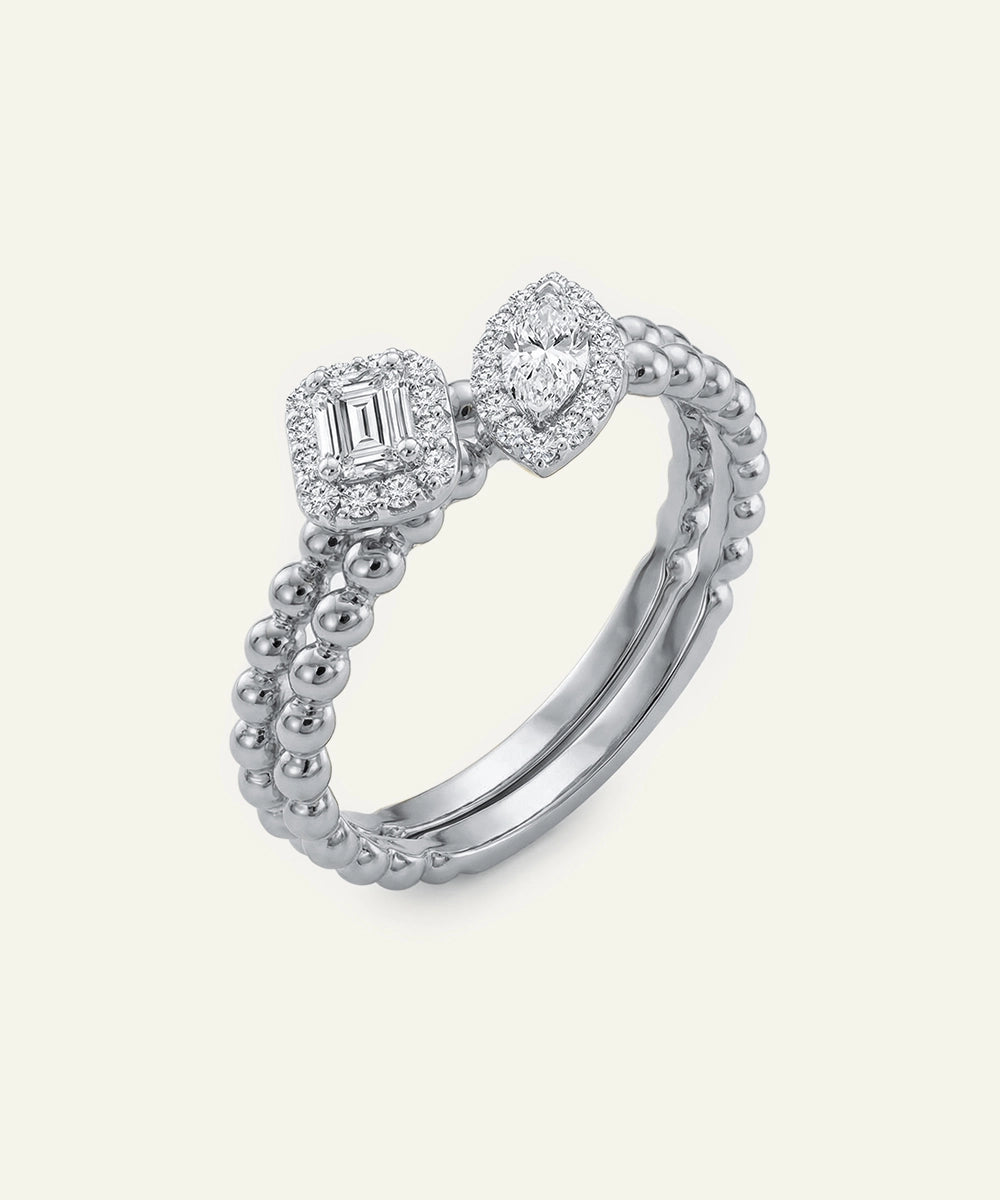 Silver ring with diamond accents on a light gray background