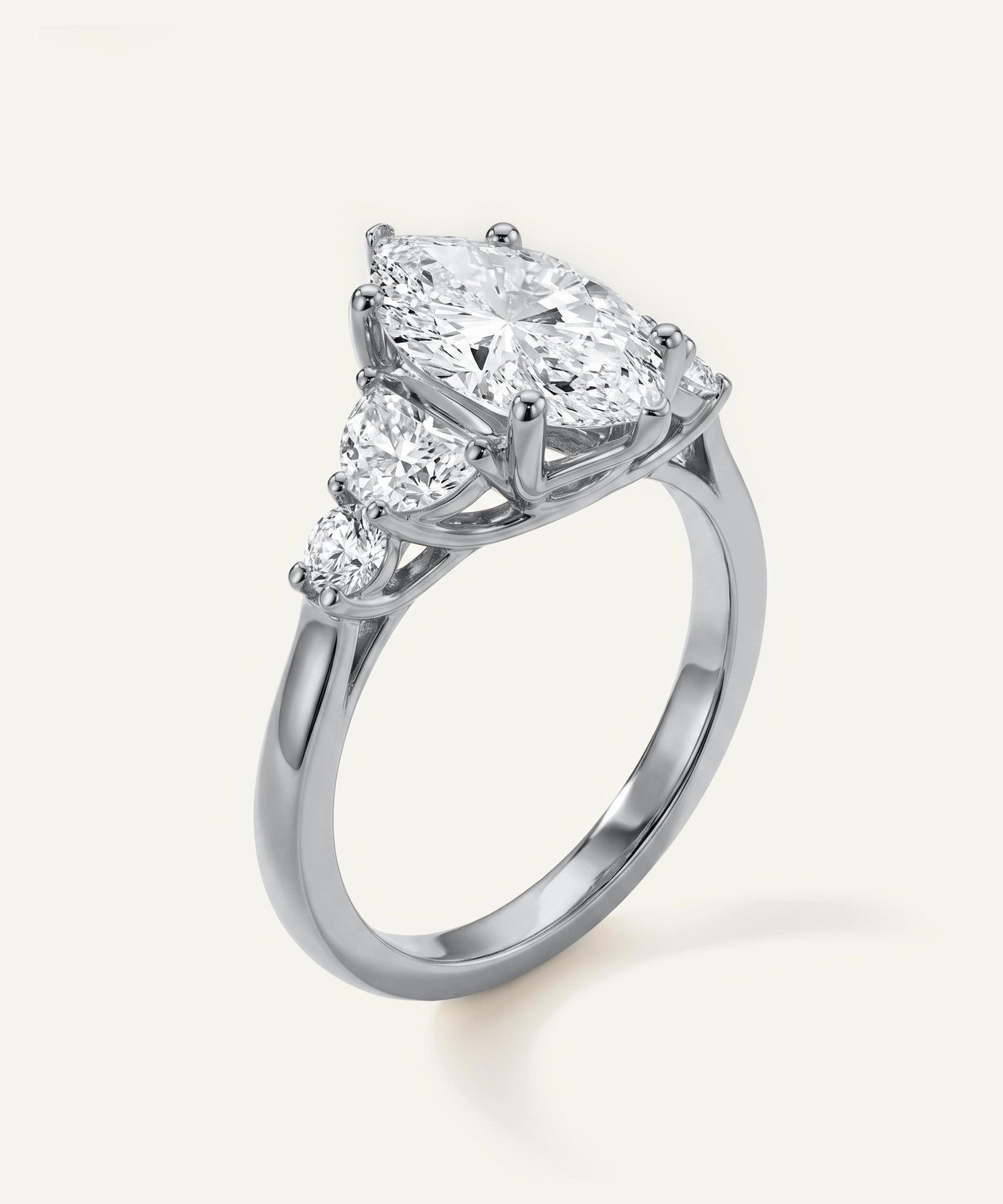 Diamond ring with a pear-shaped center stone on a white background