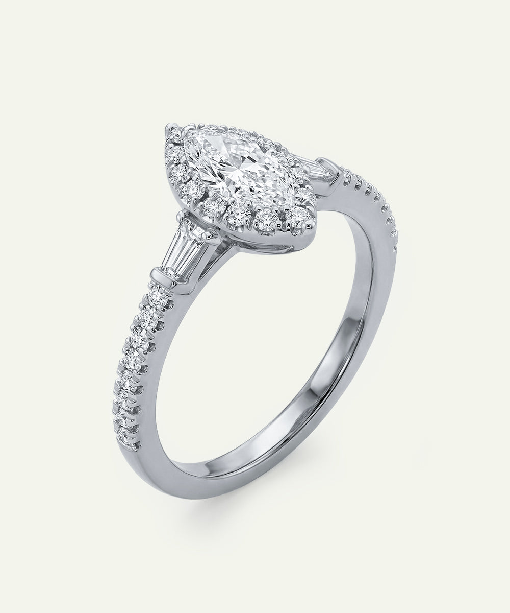Diamond ring with a pear-shaped center stone on a white background