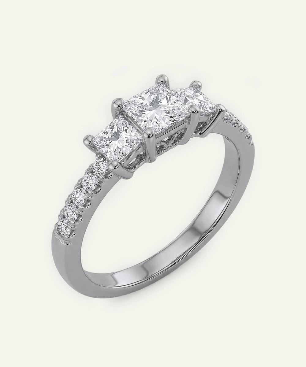 Diamond ring with three-pronged setting on a white background