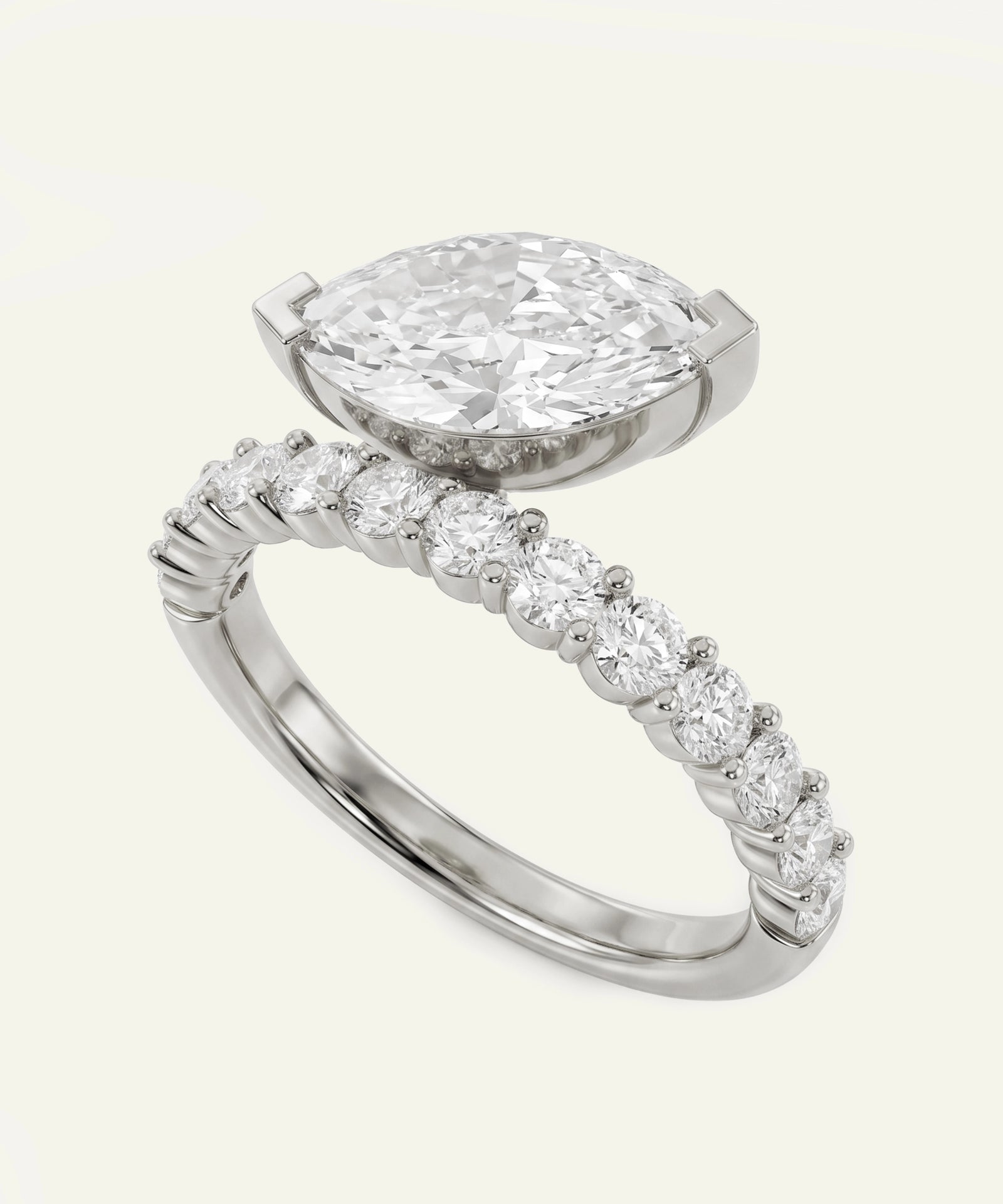 Diamond ring with a pear-shaped center stone on a white background