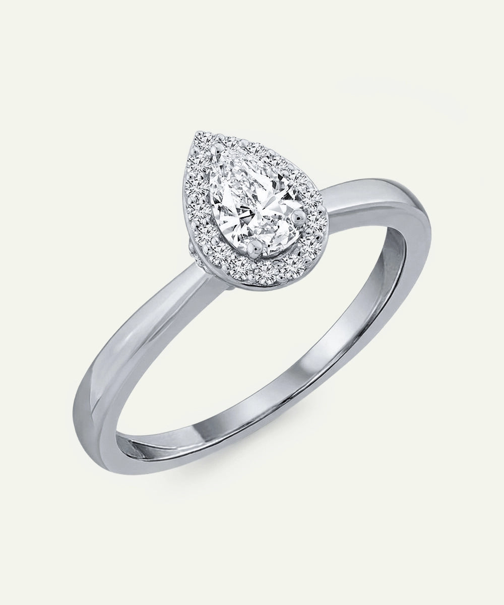 Silver ring with a pear-shaped diamond on a white background