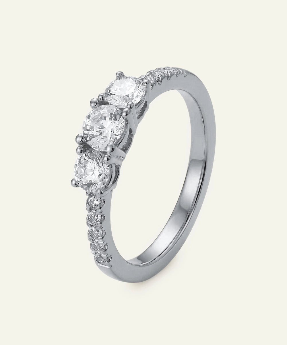 Diamond ring with multiple stones on a light gray background