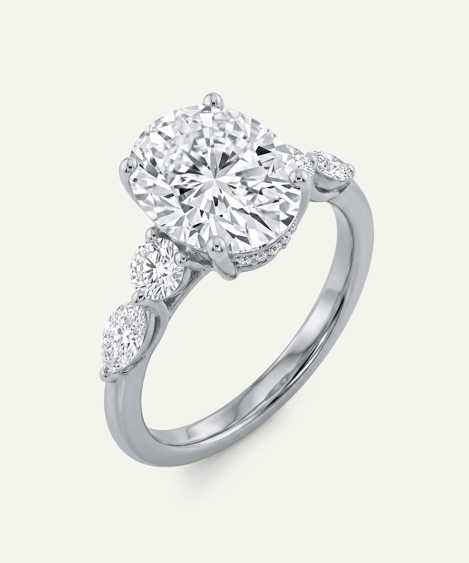 Diamond ring with three diamonds on a light gray background
