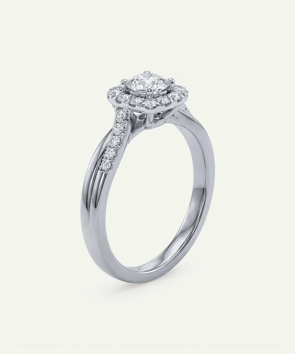 Diamond ring with a halo setting on a white background