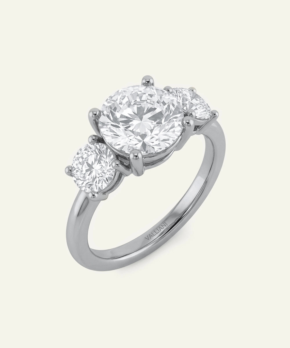 Diamond ring with three stones on a white background