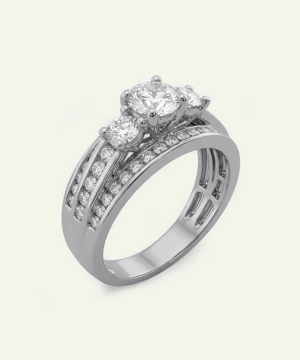 Diamond ring with three prominent diamonds on a light gray background