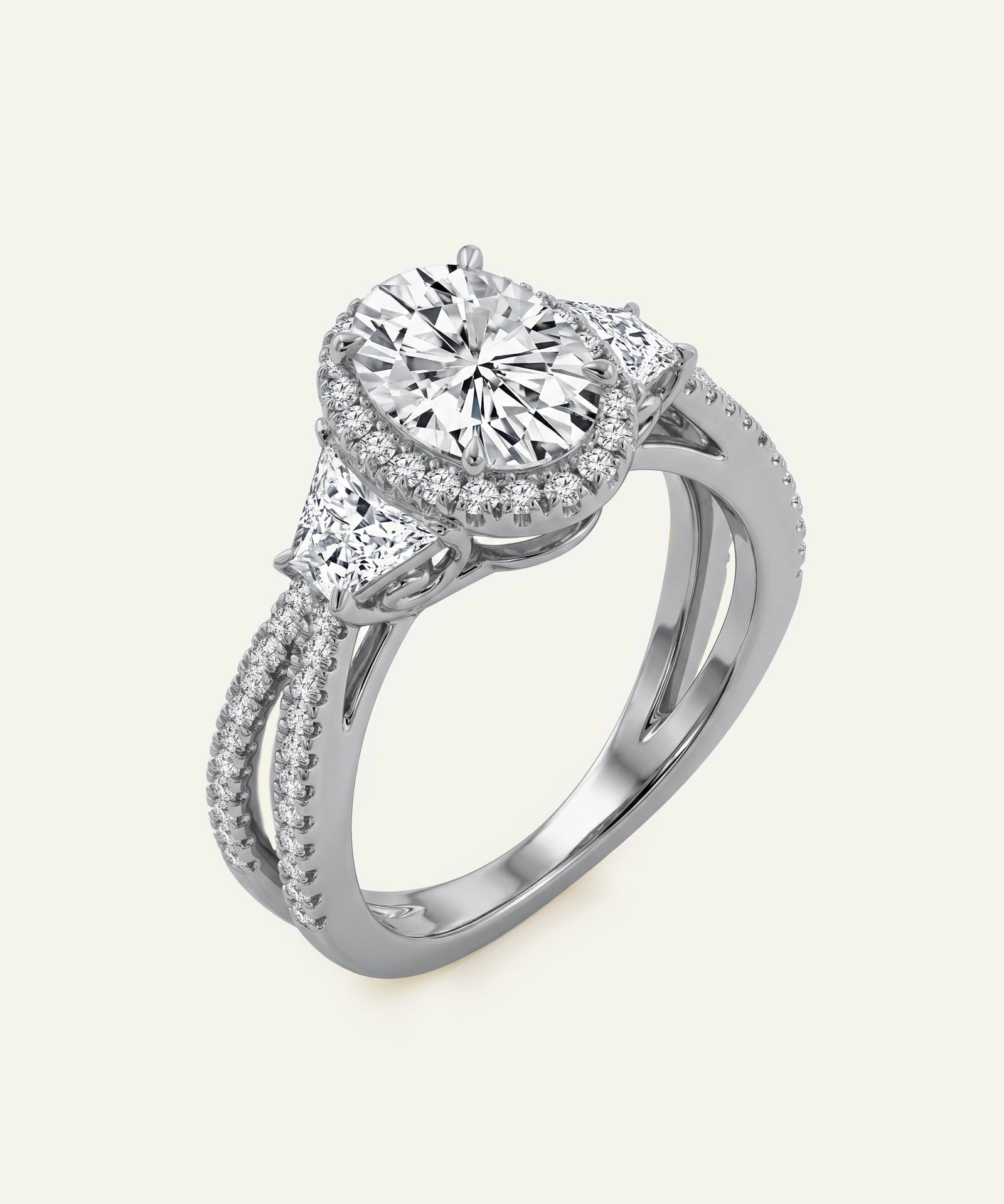 Silver ring with a large diamond and smaller diamonds on the band against a white background