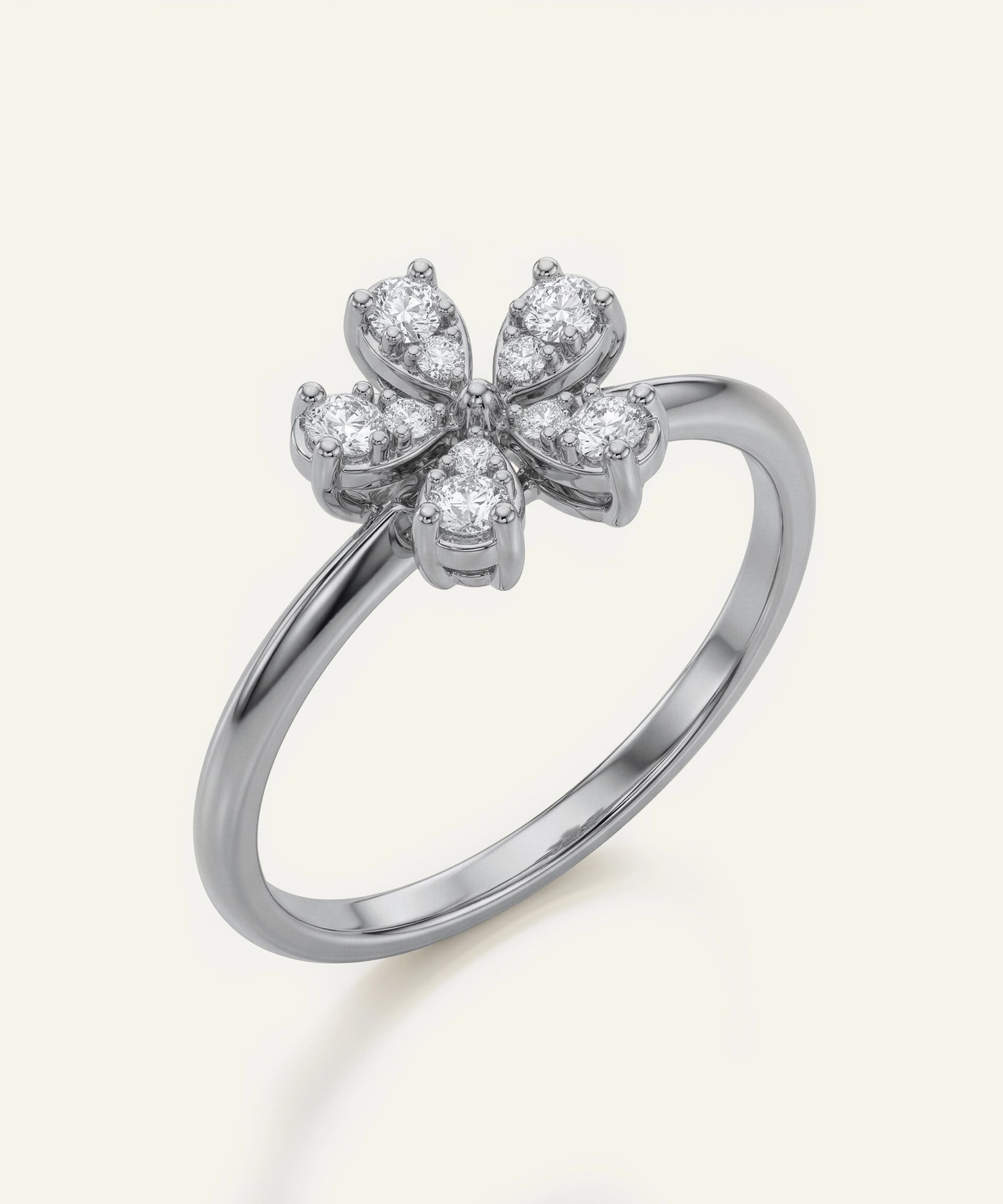 Silver ring with diamond flower design on a white background