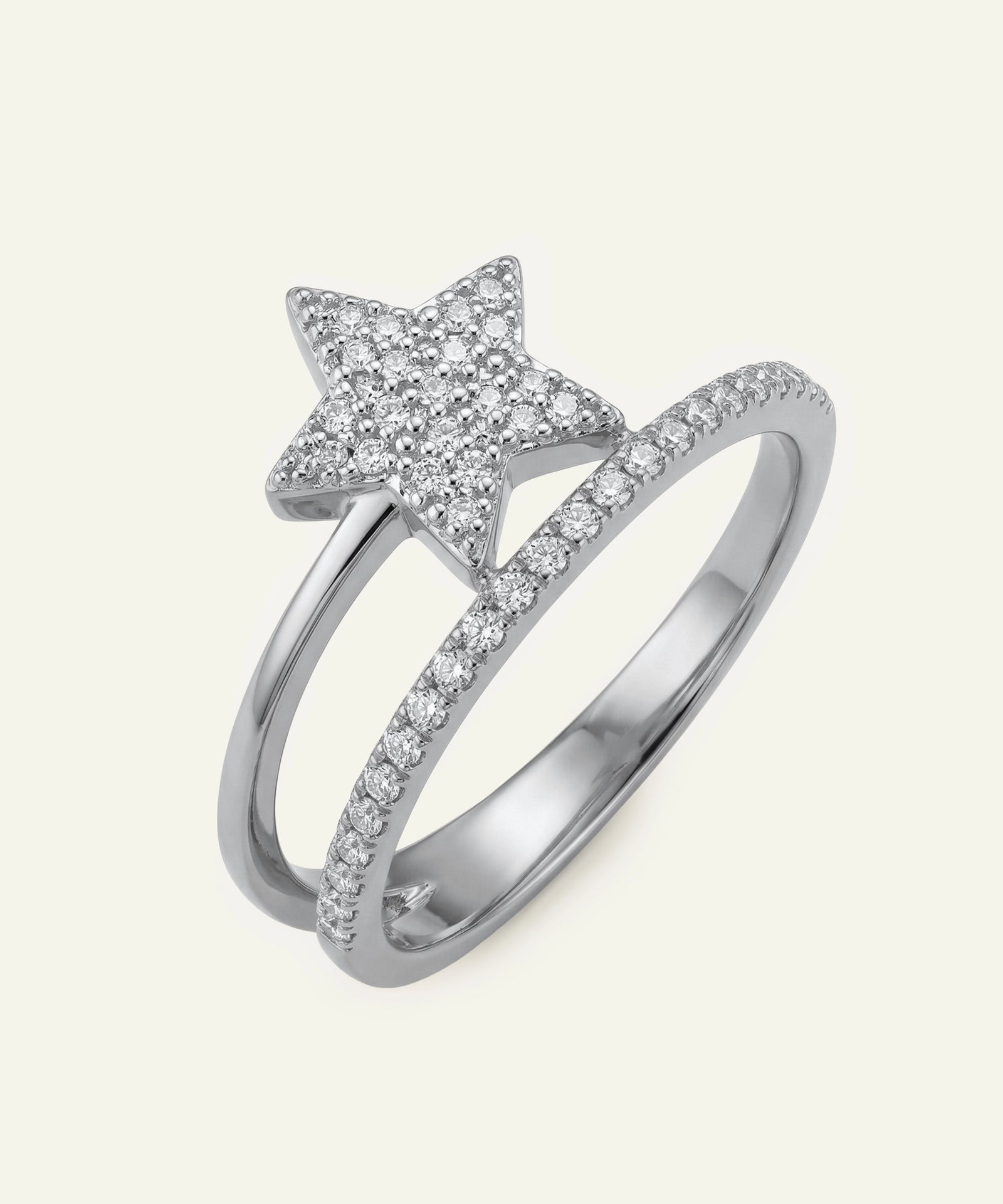 Silver ring with star-shaped design on a light gray background