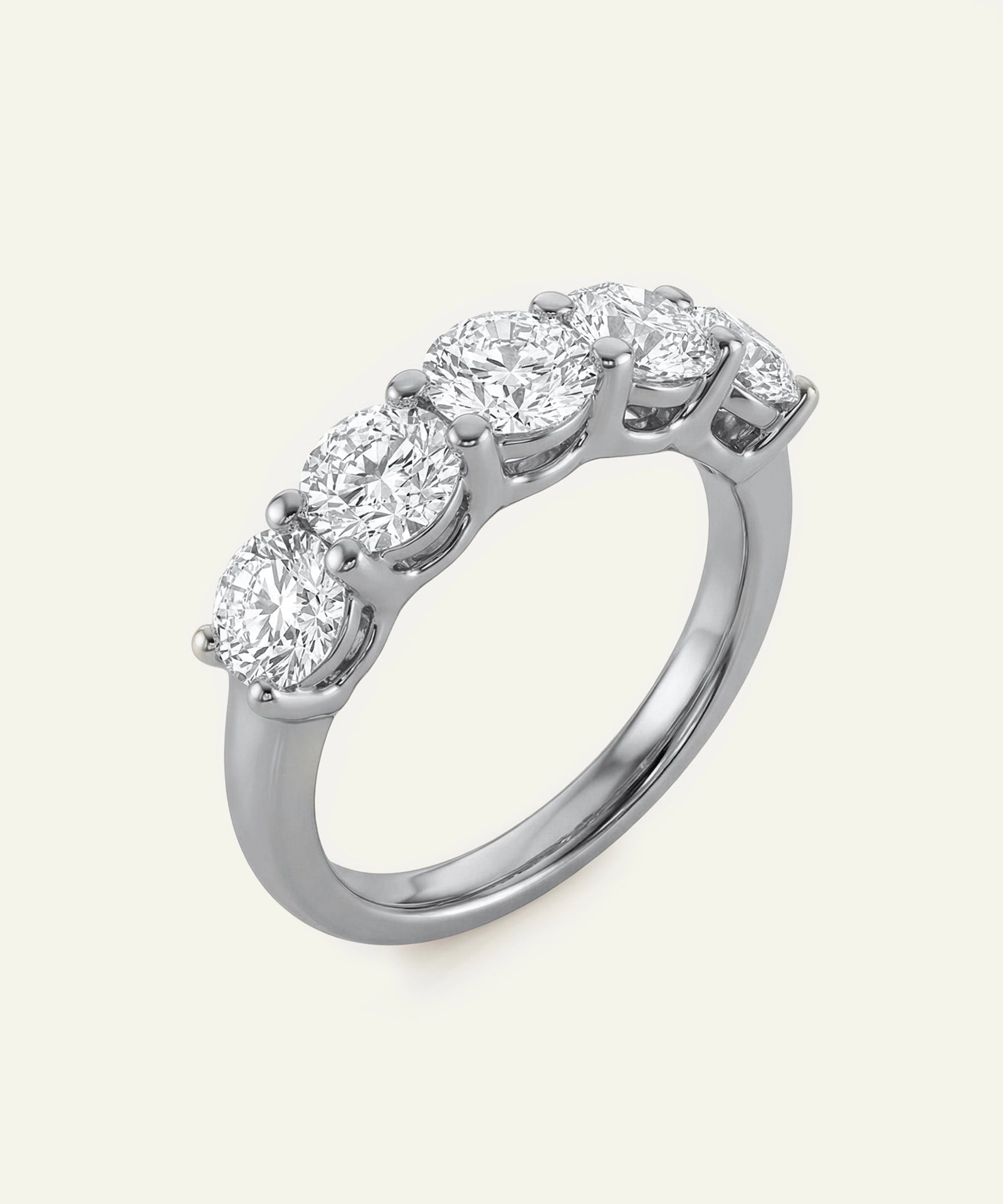 Diamond ring with five round-cut diamonds on a white background