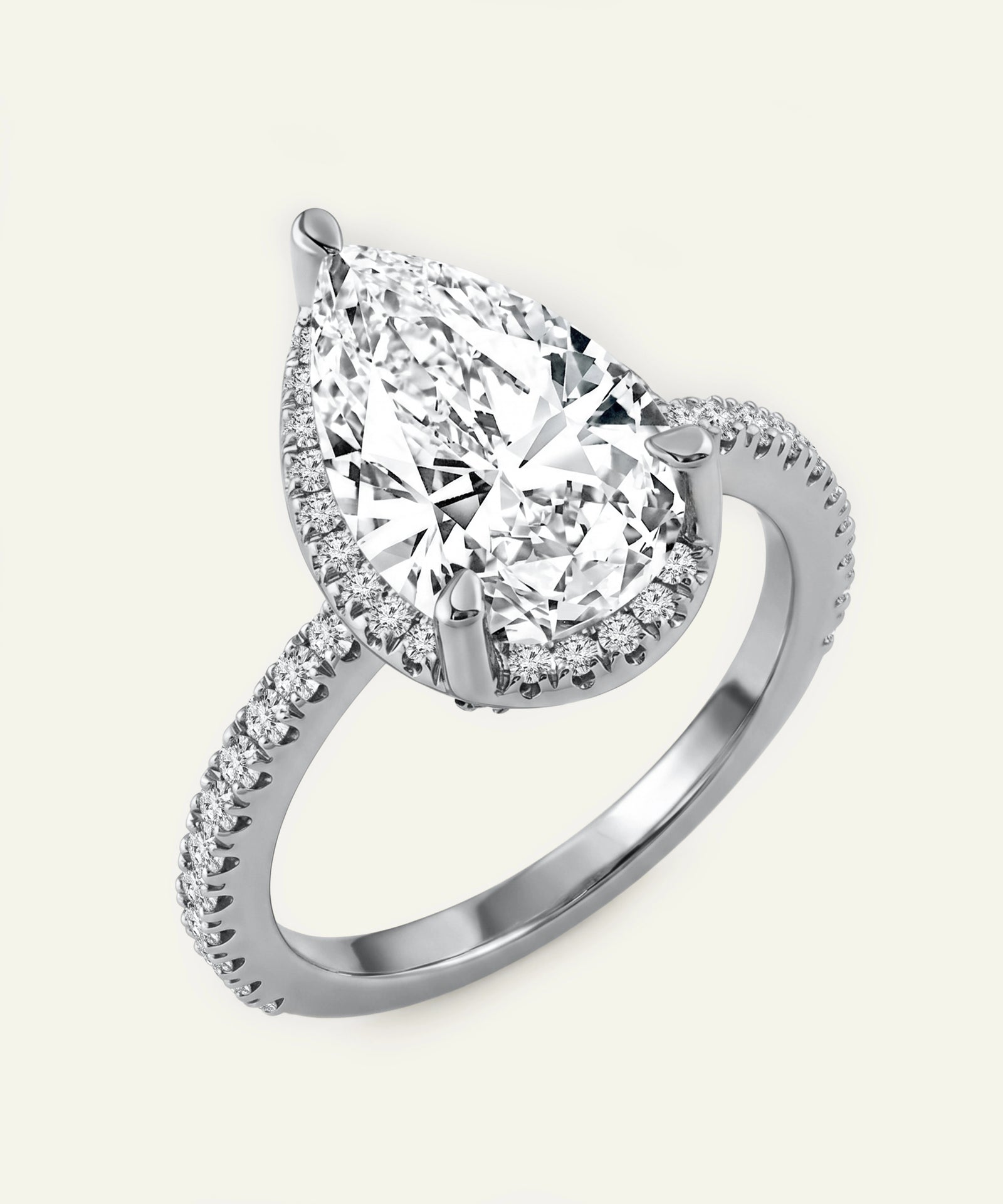Diamond ring with a pear-shaped center stone on a white background