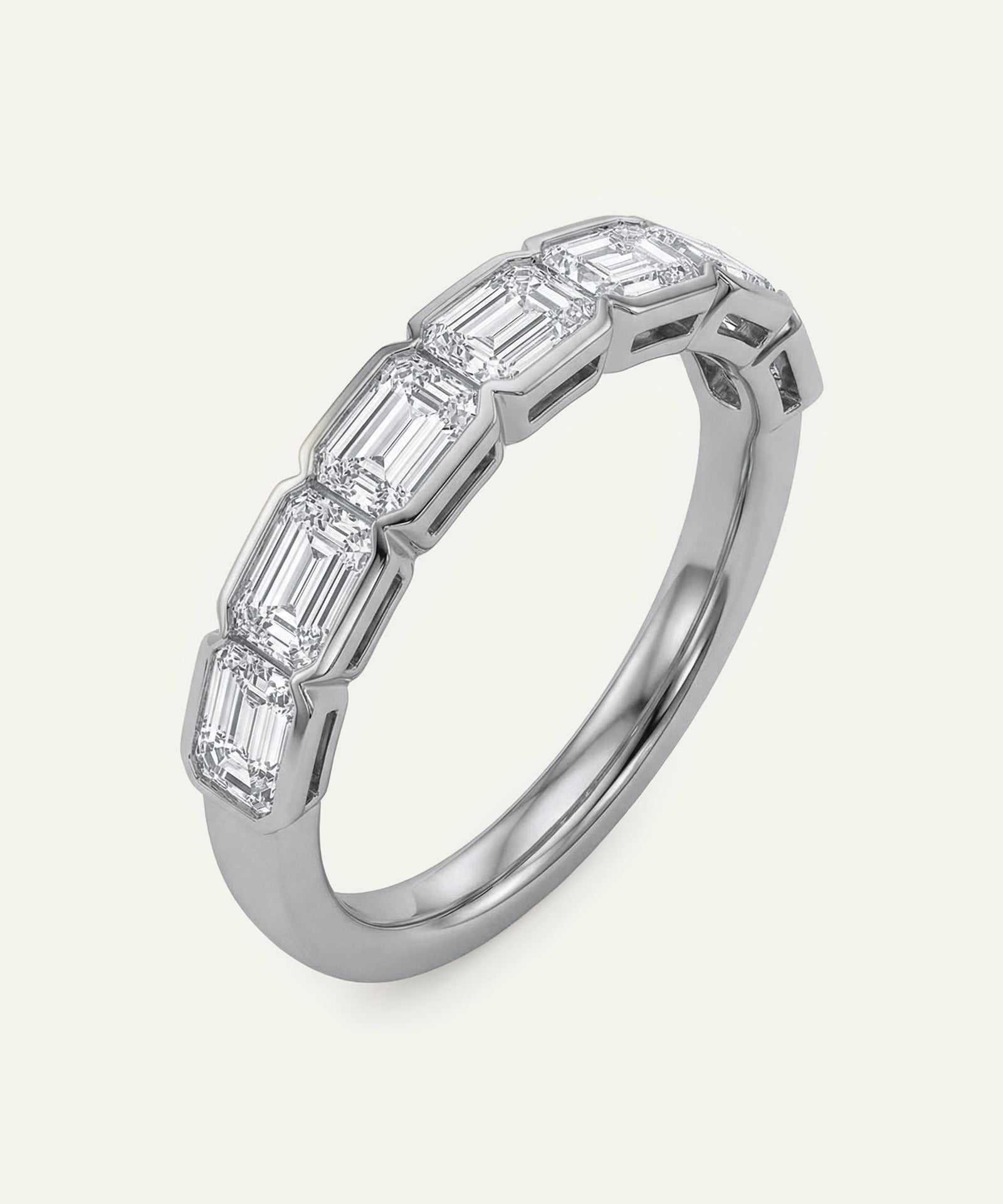 Diamond ring with baguette-cut stones on a white background