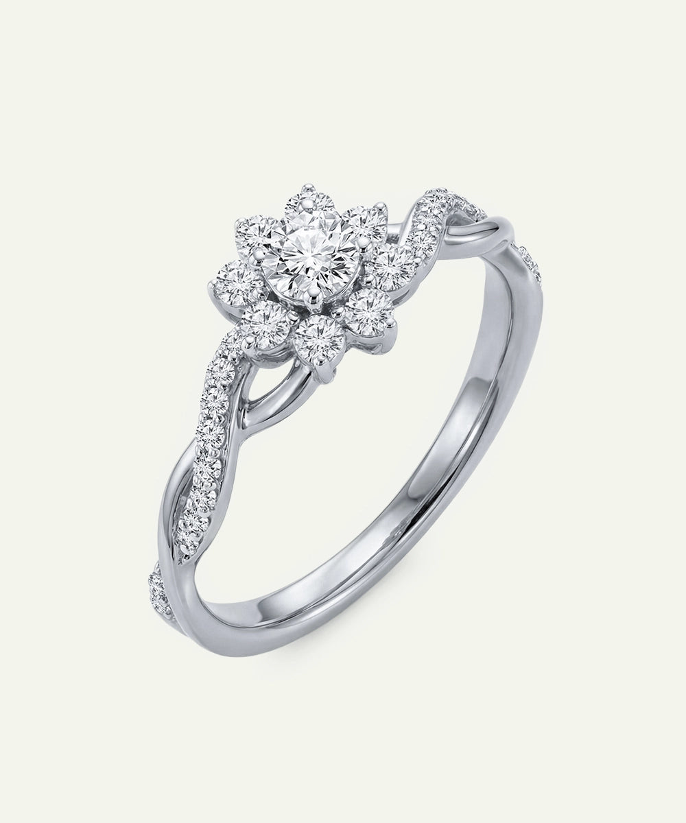 Silver ring with a pear-shaped diamond center on a white background