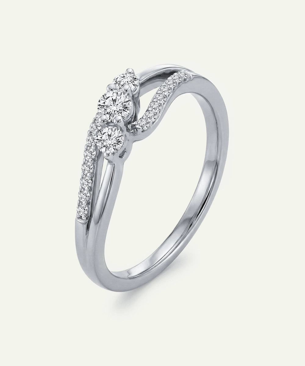 Silver ring with diamond accents on a light gray background