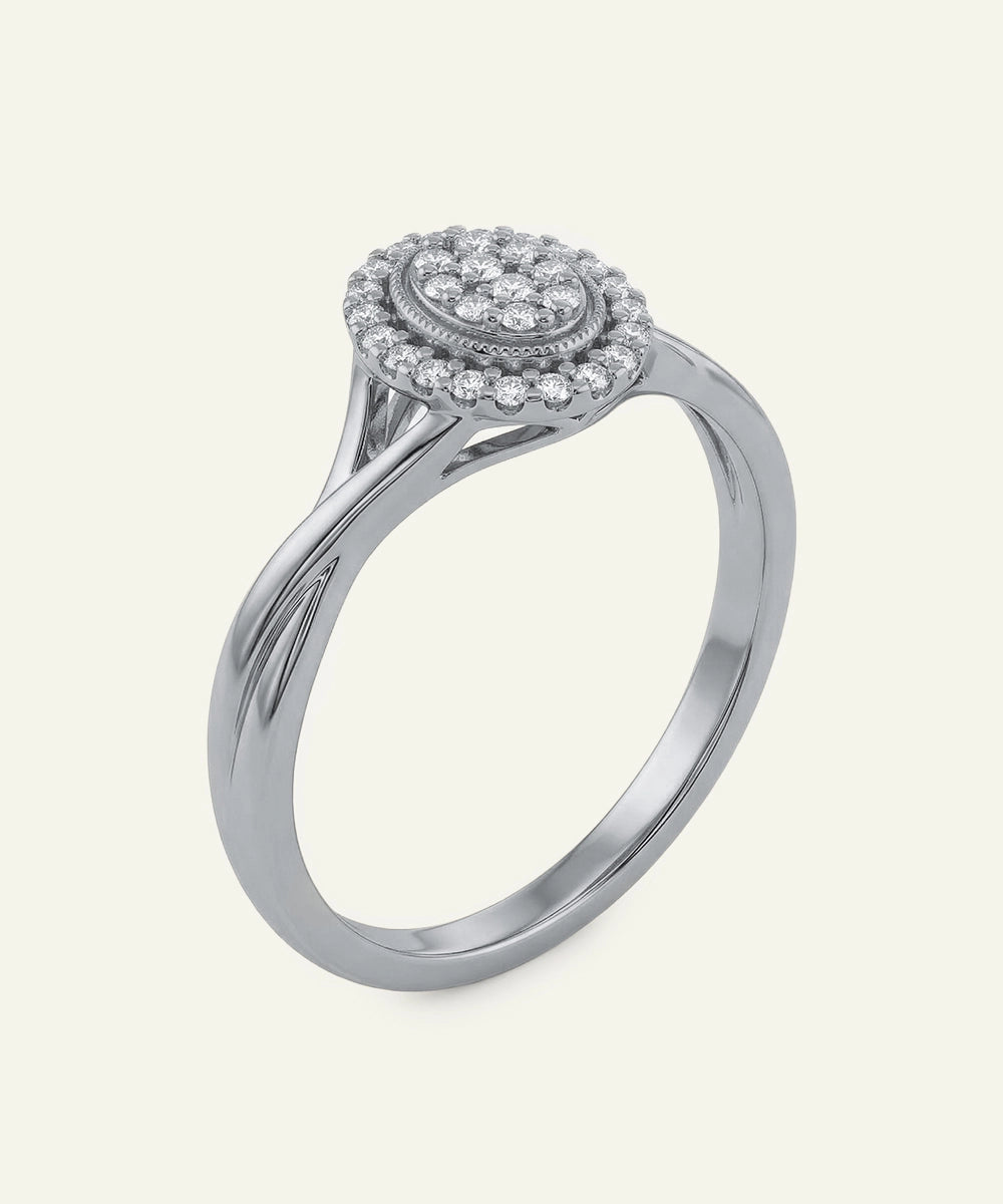 Silver ring with diamond halo on a light gray background