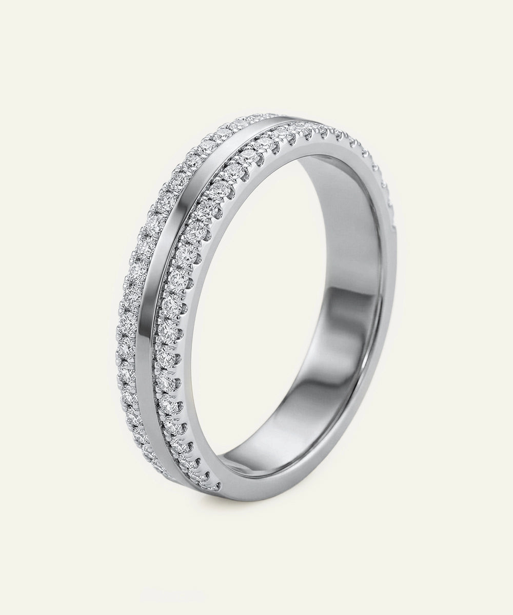Silver ring with diamond accents on a light gray background