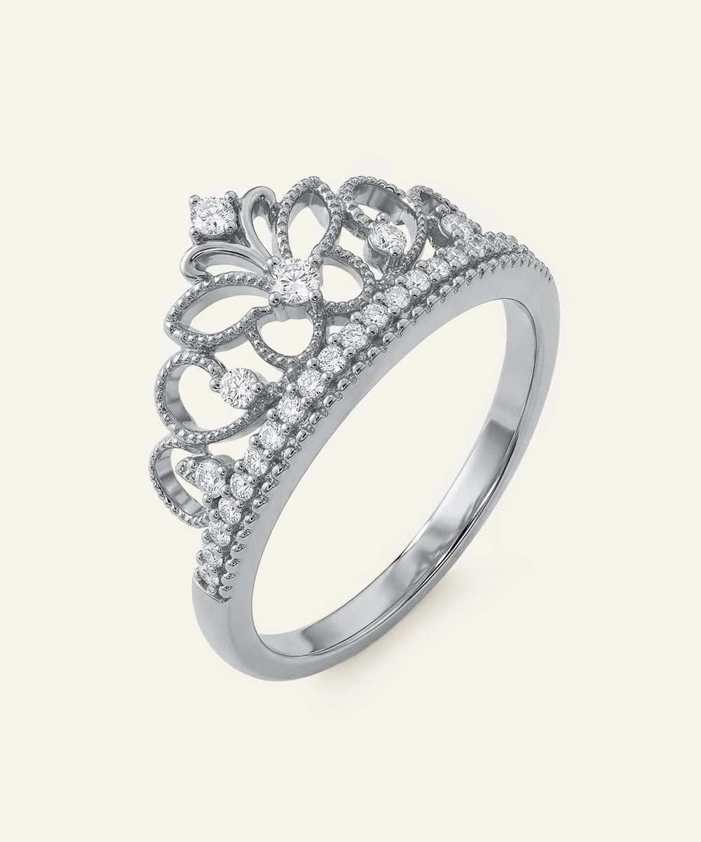 Silver ring with diamond accents on a white background