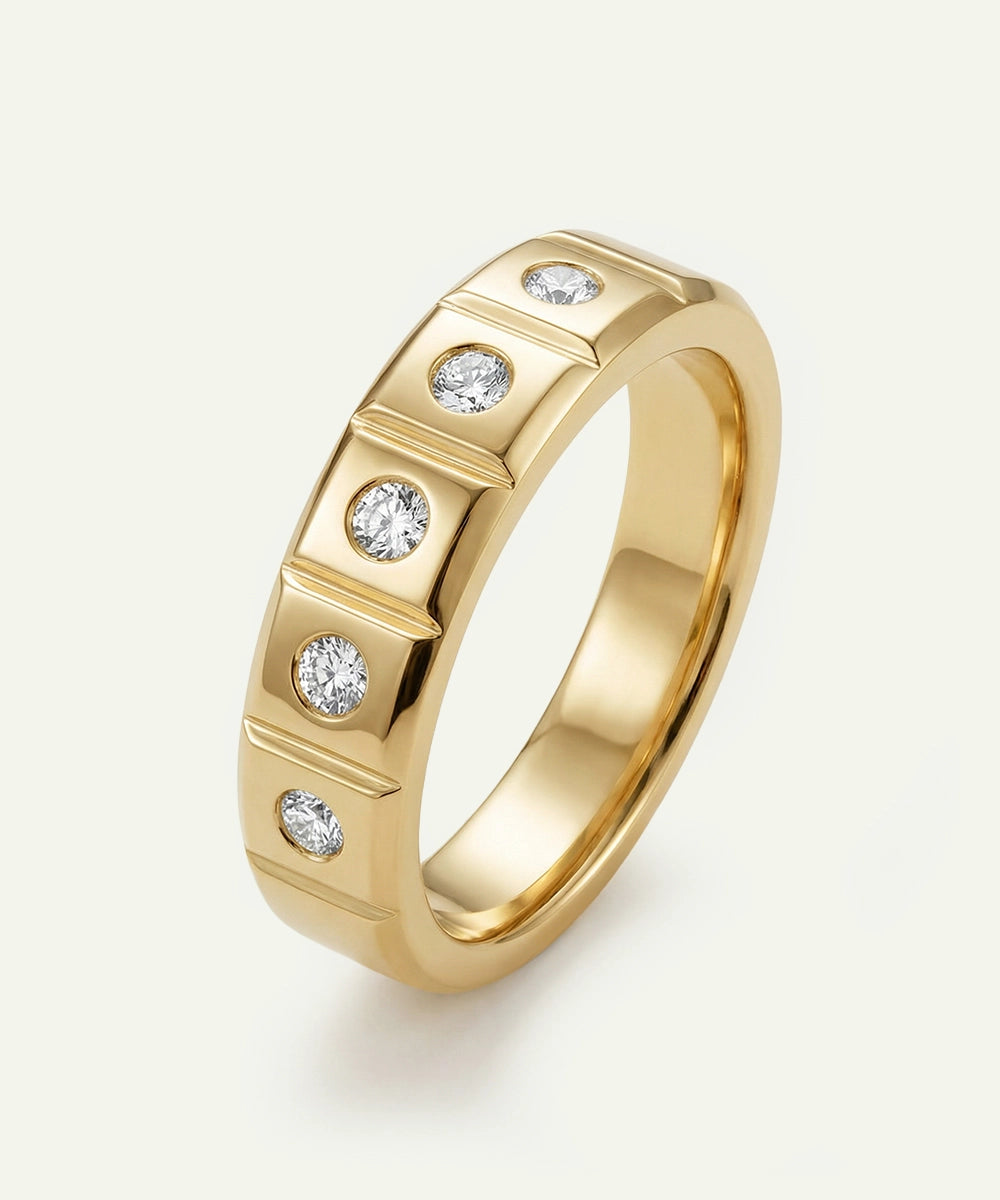 Gold ring with embedded diamonds on a light beige background