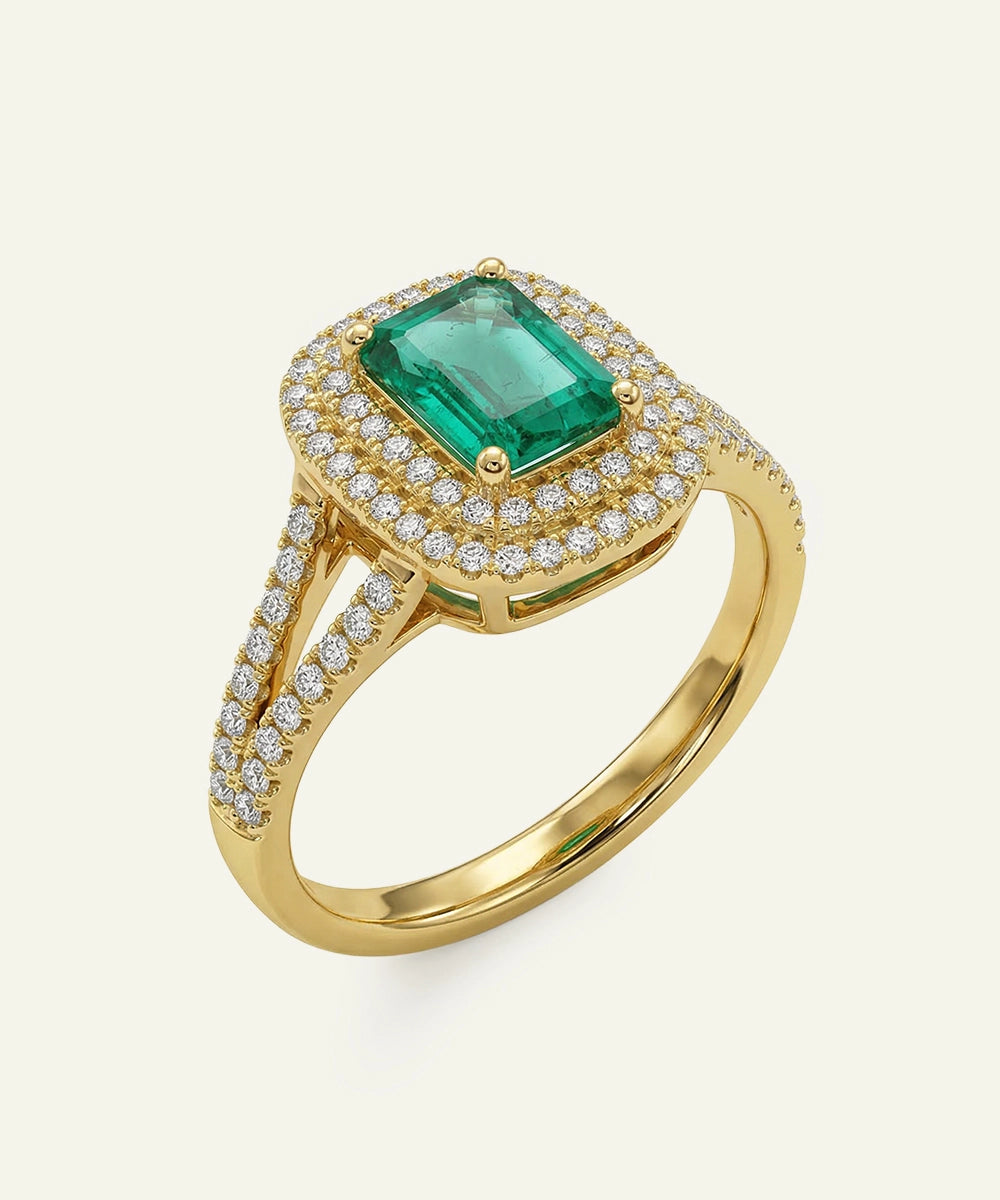 Gold ring with a green gemstone and diamond accents on a white background