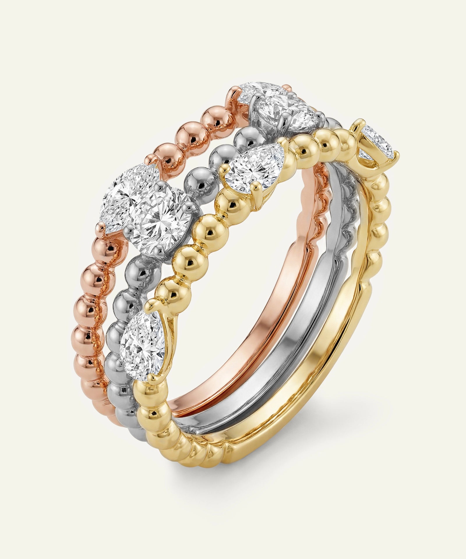 Three gold rings with diamond accents on a white background