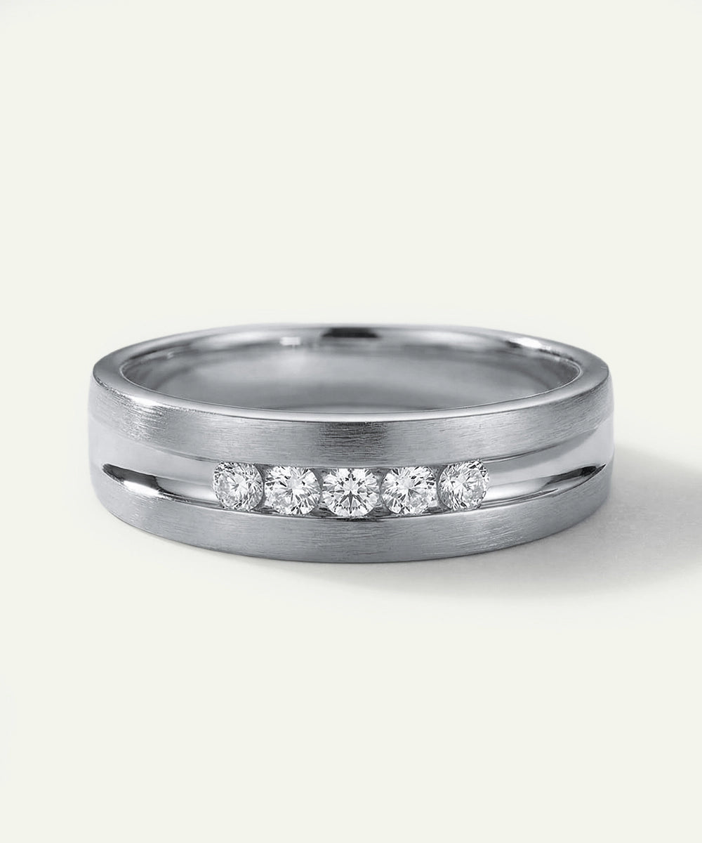 Silver ring with embedded diamonds on a white background