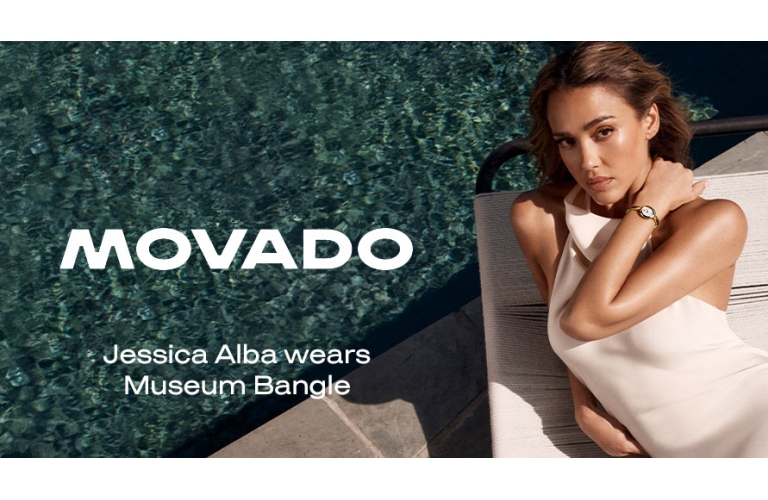 Woman wearing Movado Museum Bangle watch reclining poolside in luxury setting