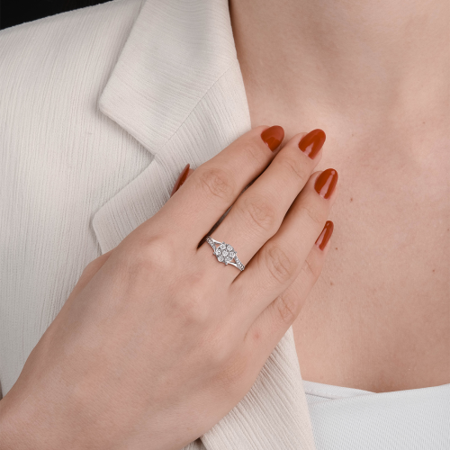 A woman elegantly showcasing a flower-shaped Novello lab-grown diamond, symbolizing brilliance and sustainability.
