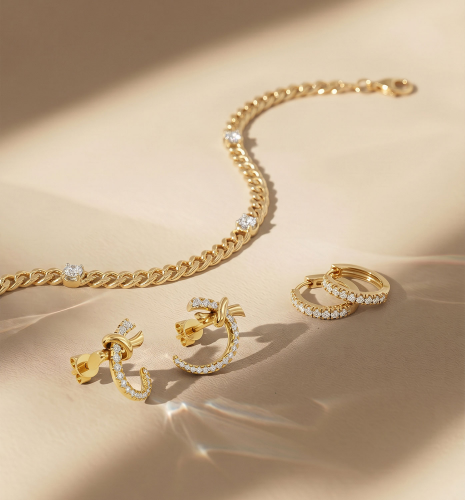 Gold diamond heart necklaces, floral diamond stud earrings, initial “J” pendant, and solitaire diamond necklace displayed on red velvet